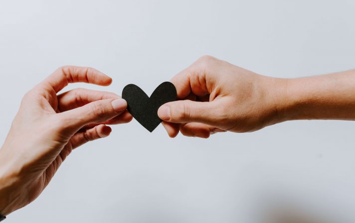 Two hands holding a heart indicating good collaboration